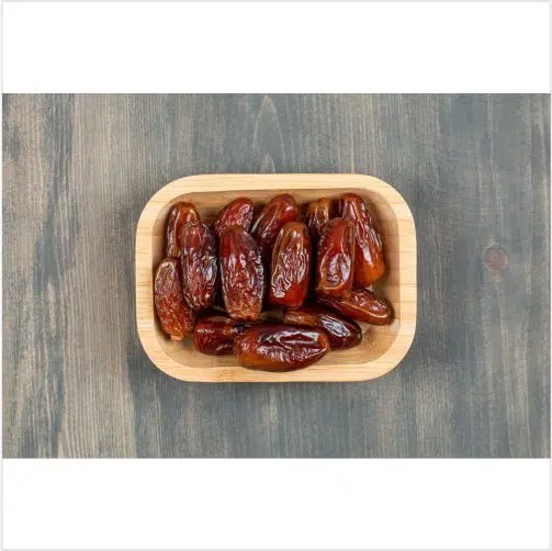 juicy dates wooden plate wooden table high quality photo 1 تصویر