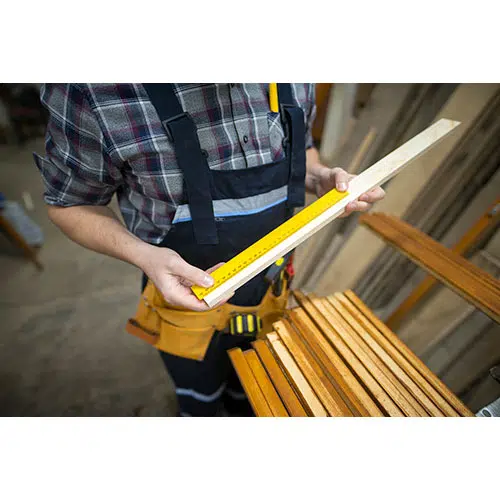 carpenter taking measurements plank he is about cut woodworking workshop 1 تصویر