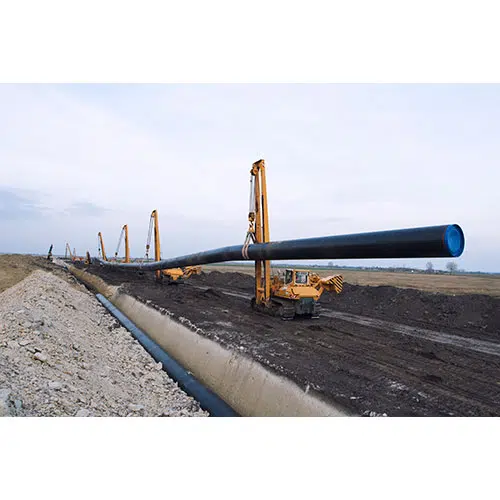 heavy duty construction machines carrying placing gas pipe into ground 1 تصویر