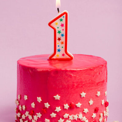 کیک تولد با شمع شماره 1 یک روشن با زمینه بنفش