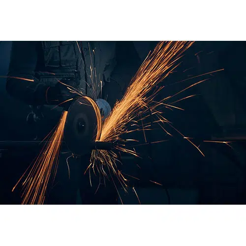 worker polishing metal with special equipment dark room 1 تصویر