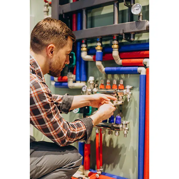 young engineer adjusting autonomous heating 1 تصویر
